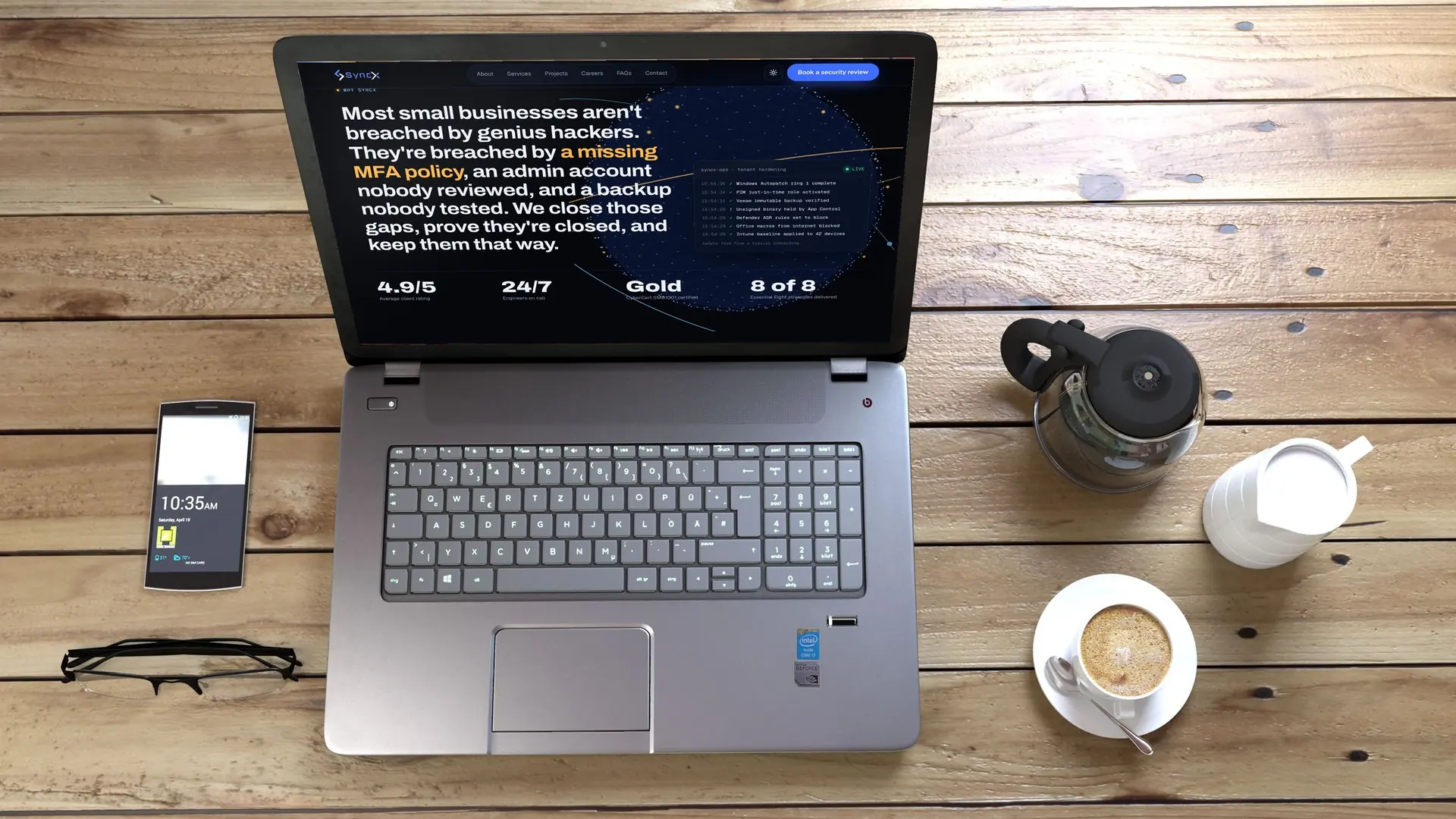 Laptop on a timber table showing the SyncX live operations view